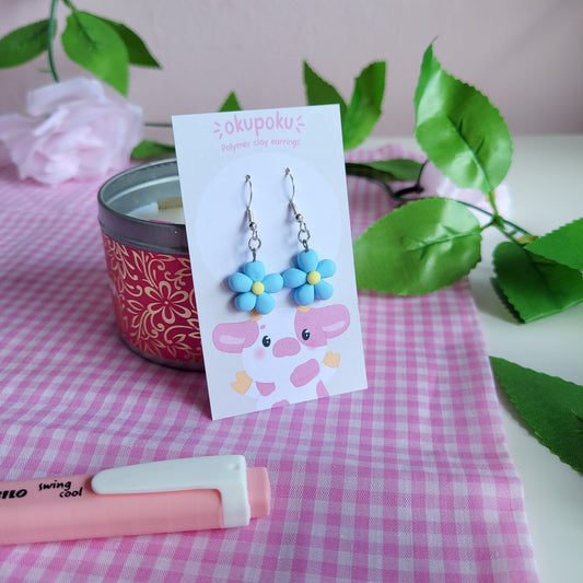 cute handmade blue daisy earrings made out of polymer clay