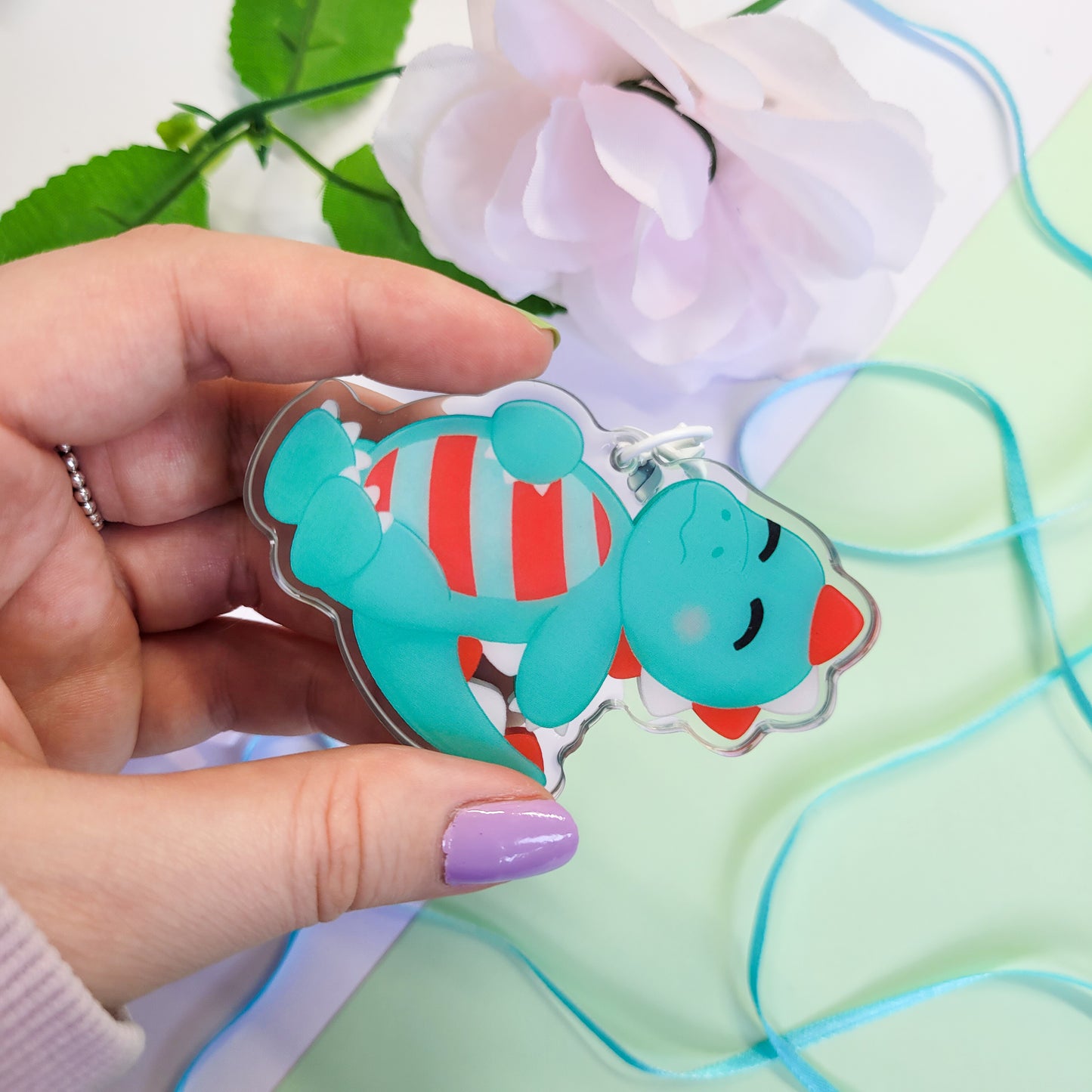 Peppermint T-Rex shaker keychain with a belly full of sweets