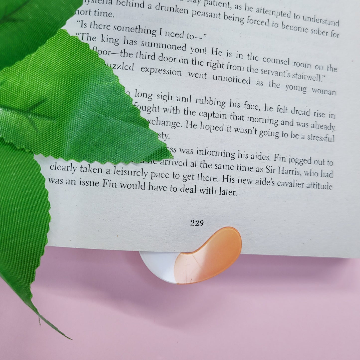 Cute cat shaped bookmark shown in use