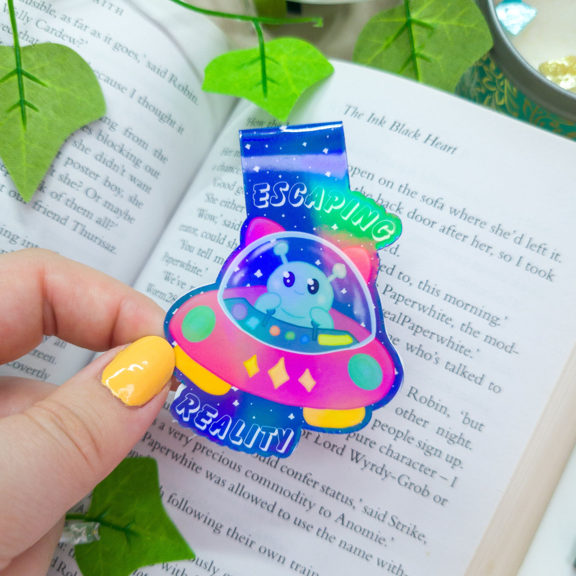 Alien magnetic bookmark featuring the text "escaping reality"
