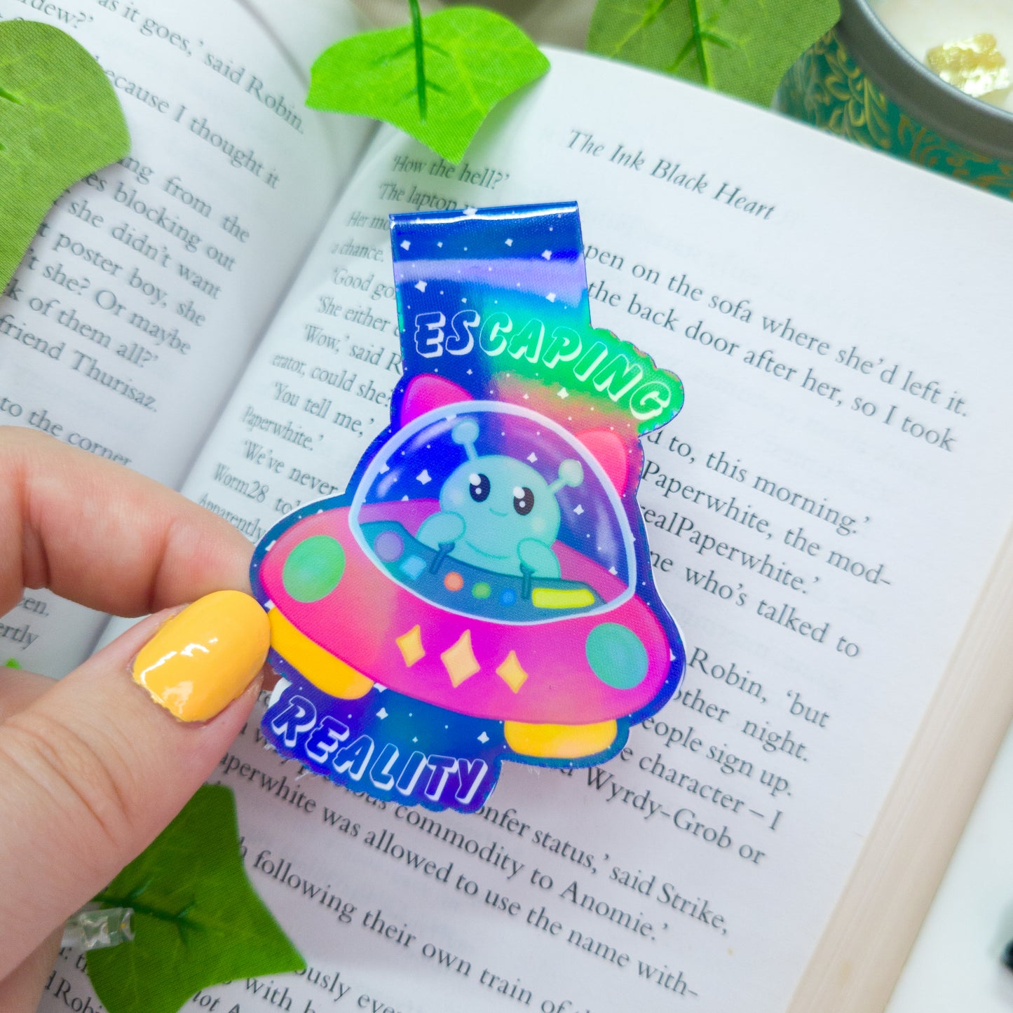 Alien magnetic bookmark featuring the text "escaping reality"