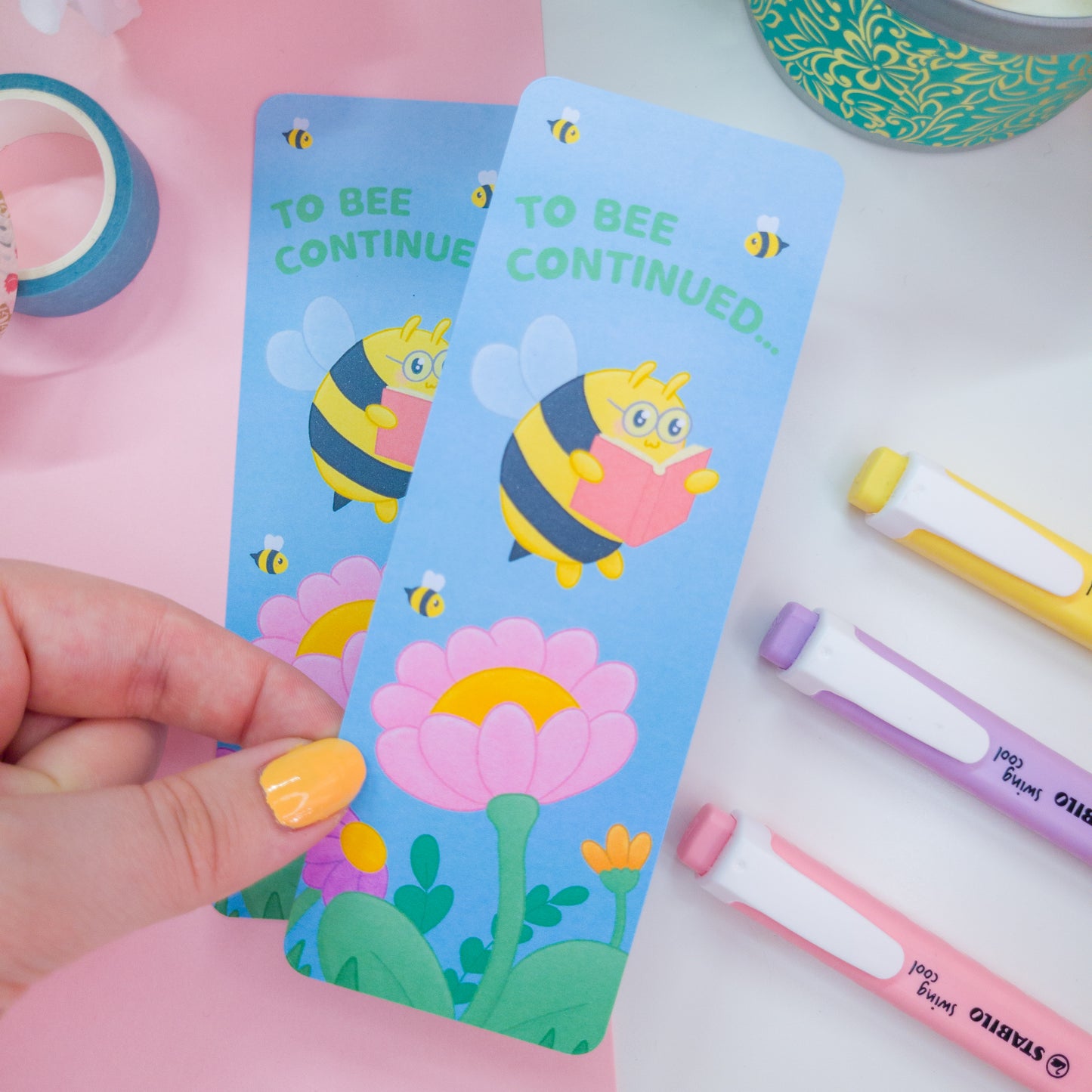 to bee continued bookmark featuring a bee reading among flowers
