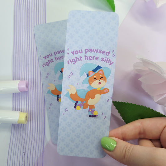 Katrina the kitty witch bookmark with her rollerskating with the text "you pawsed right here silly"