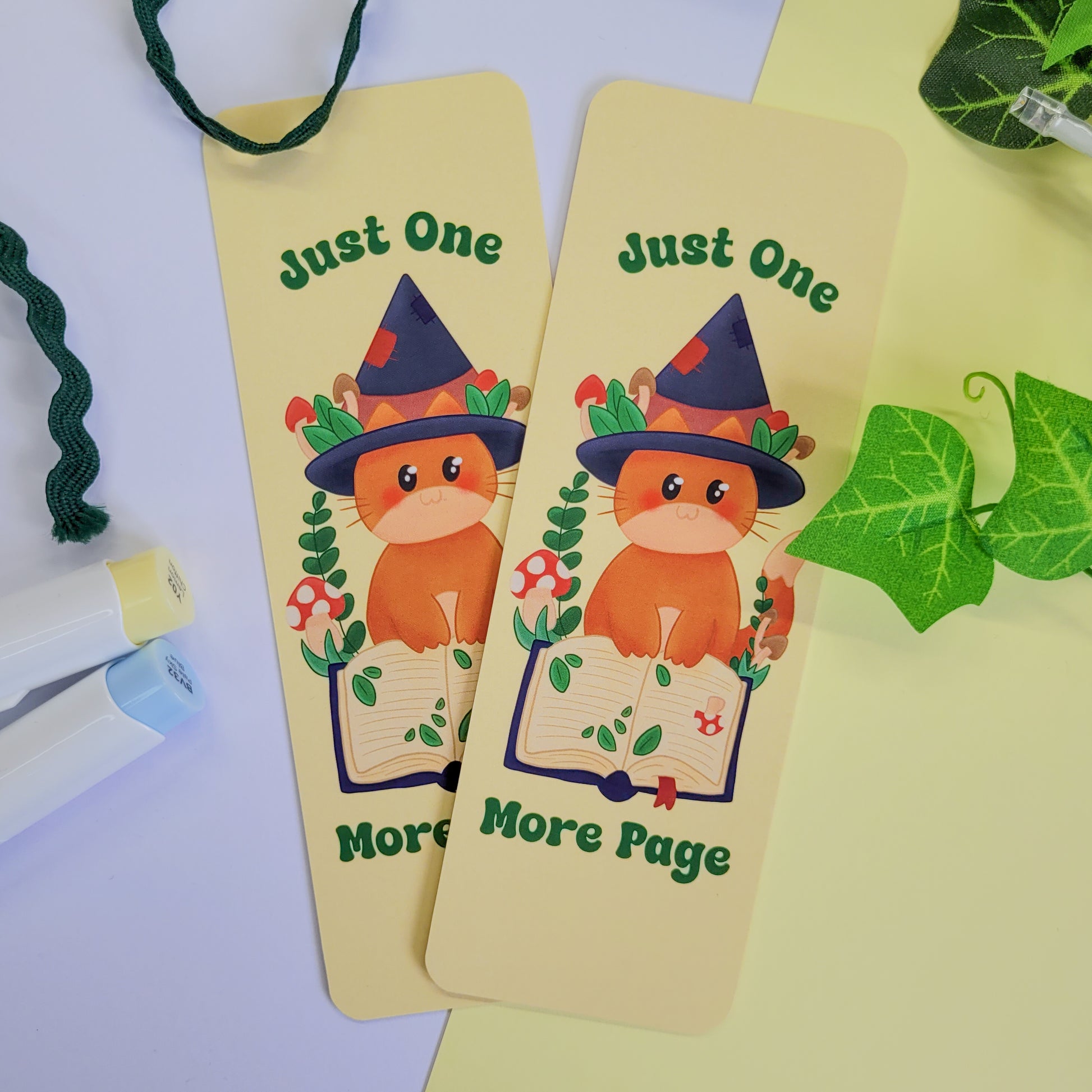 Cute cat witch bookmark featuring the text "Just one more page"