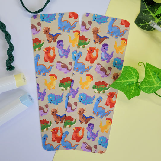 cute bookmark featuring a dinosaur design of brachiosaurus, triceratops, stegosaurus, parasaurolophus and more