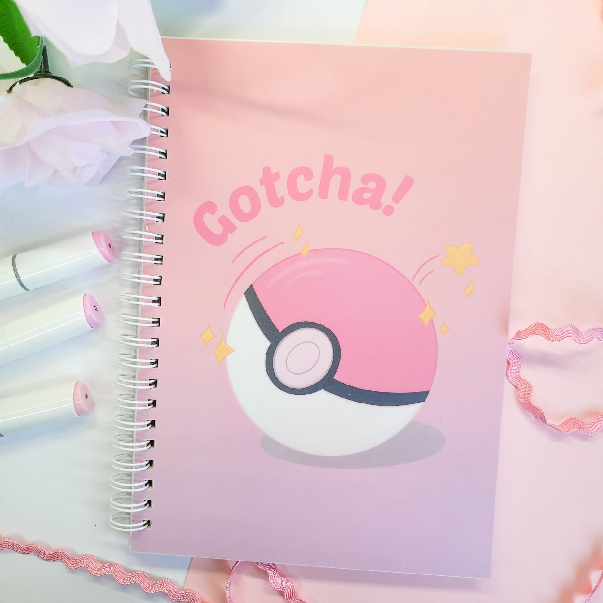 reusable sticker book with a Poké Ball design and 'Gotcha!' text on a pink background