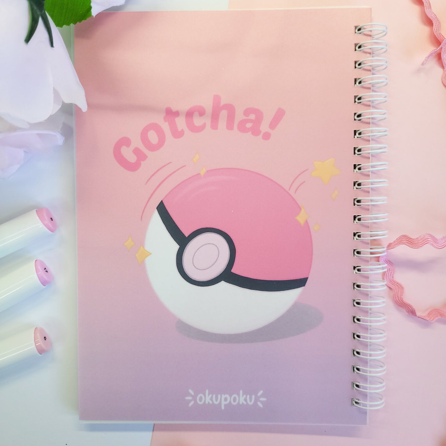 reusable sticker book with a Poké Ball design and 'Gotcha!' text on a pink background