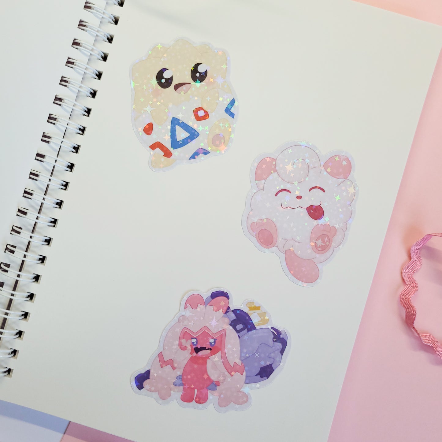 reusable sticker book with a Poké Ball design and 'Gotcha!' text on a pink background