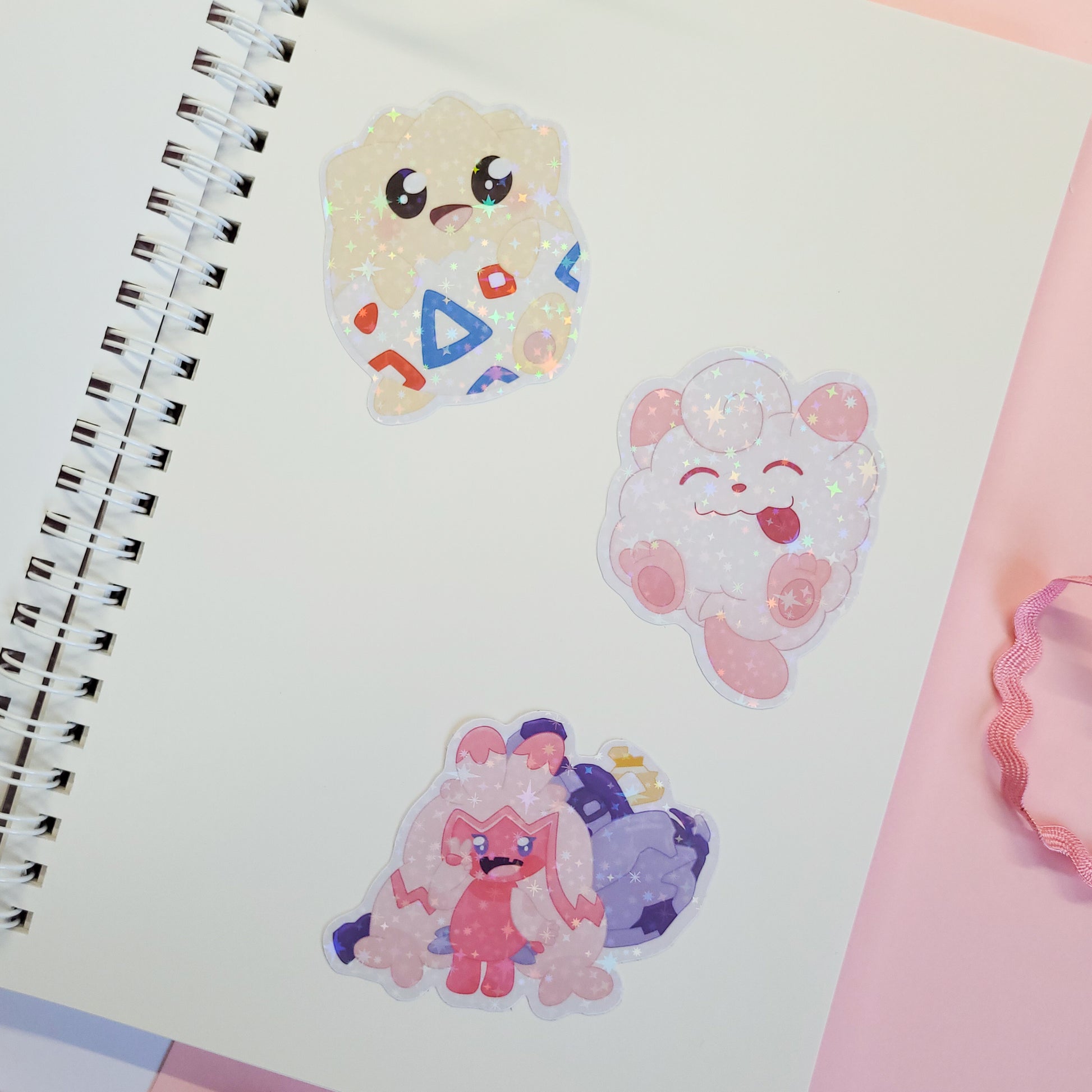 reusable sticker book with a Poké Ball design and 'Gotcha!' text on a pink background