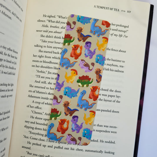 cute bookmark featuring a dinosaur design of brachiosaurus, triceratops, stegosaurus, parasaurolophus and more