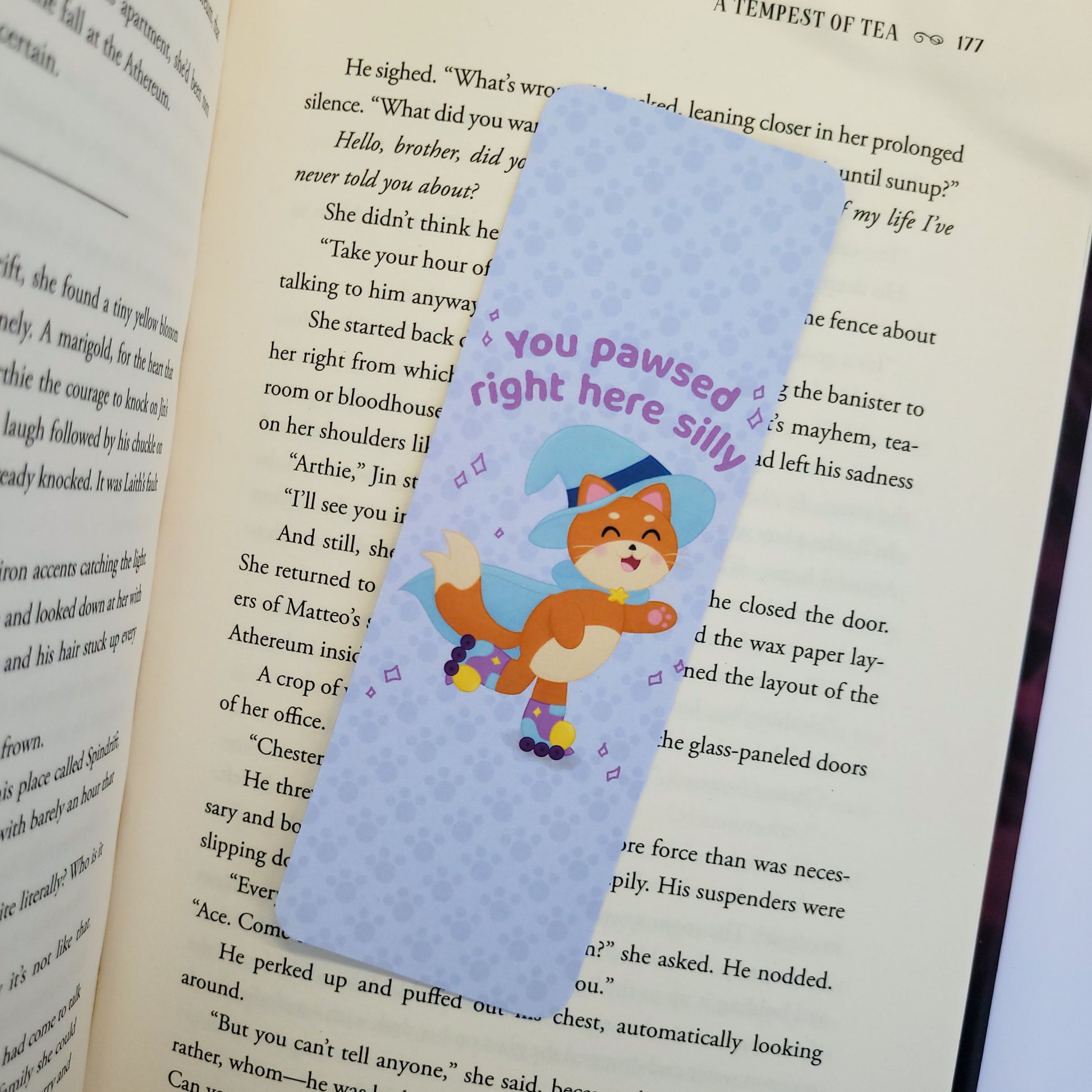 Katrina the kitty witch bookmark with her rollerskating with the text "you pawsed right here silly"