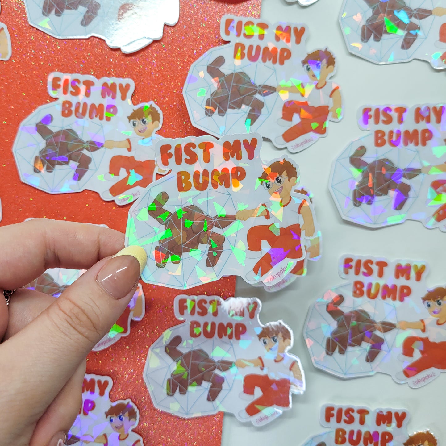 Holographic stickers with rocky and grace and text 'Fist My Bump' on a red background.