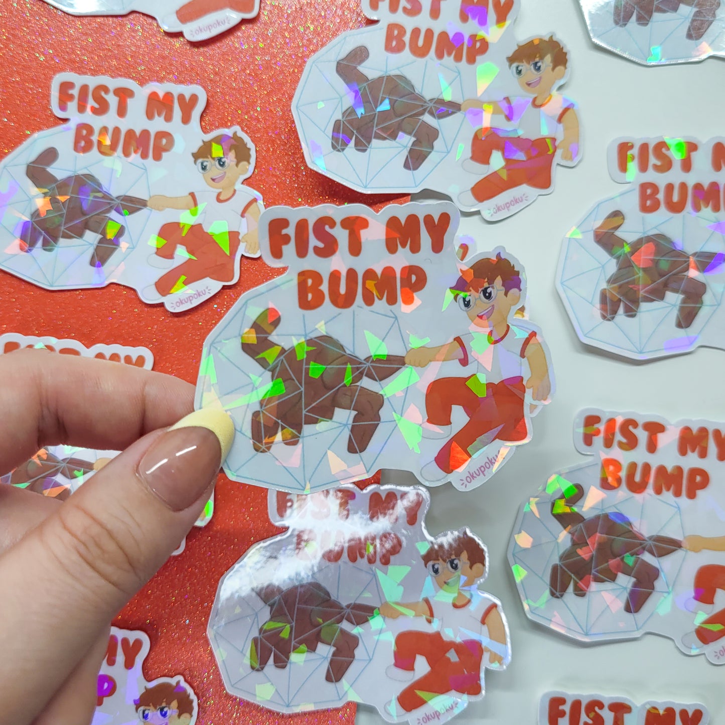 Sticker with 'Fist My Bump' text and cartoon characters held by a hand on a colorful background.