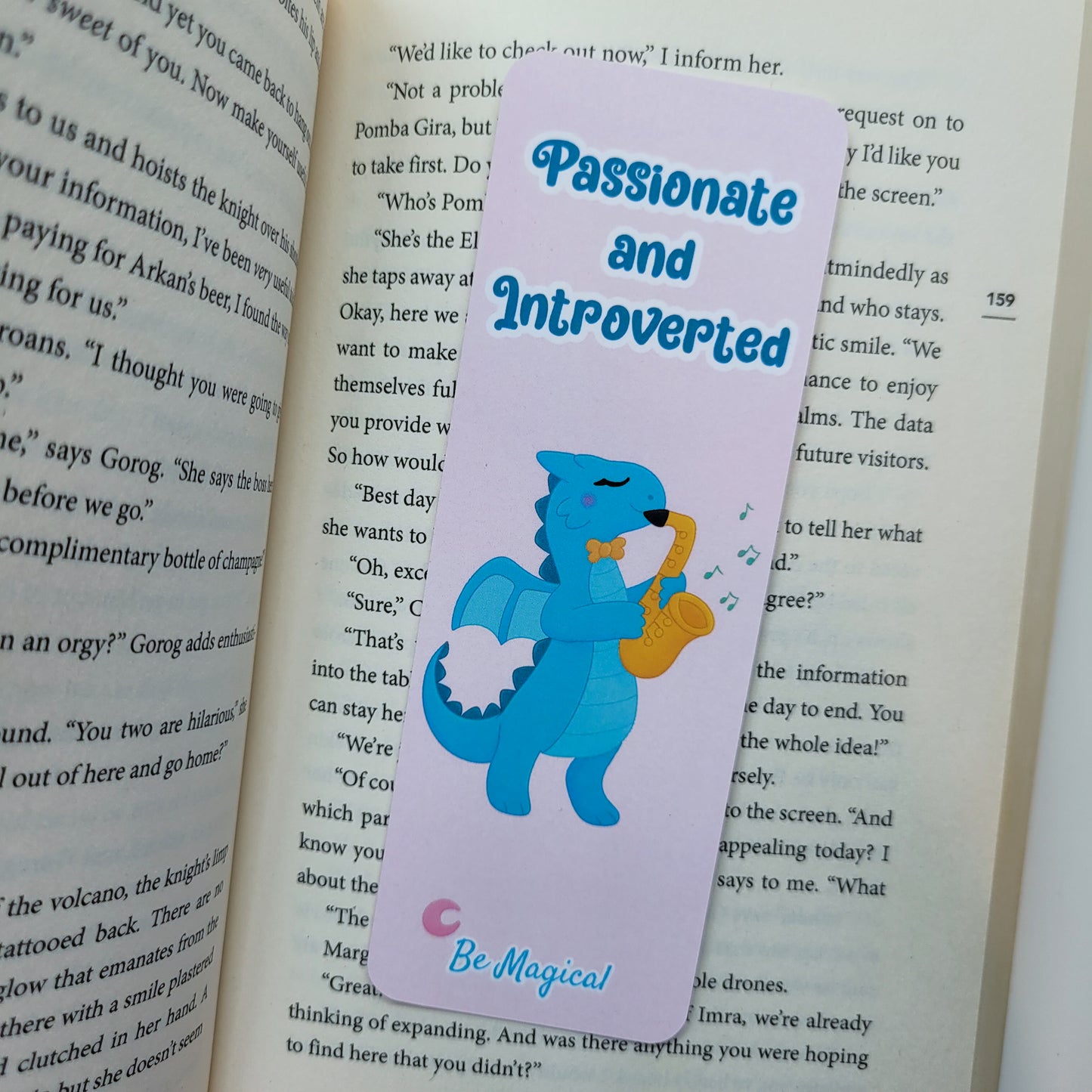 bookmark featuring "passionate and introverted" with a blue dragon playing the saxophone