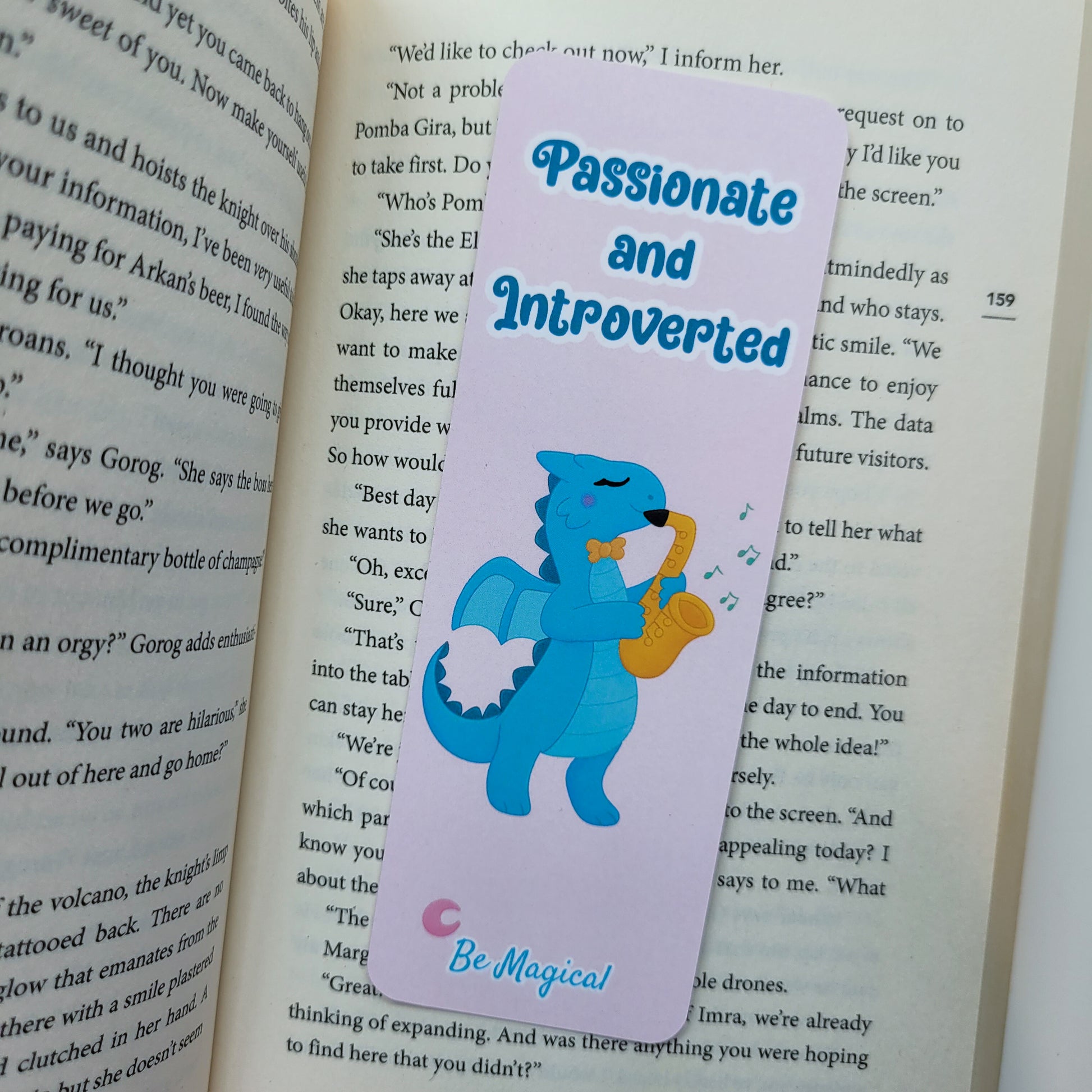 bookmark featuring "passionate and introverted" with a blue dragon playing the saxophone