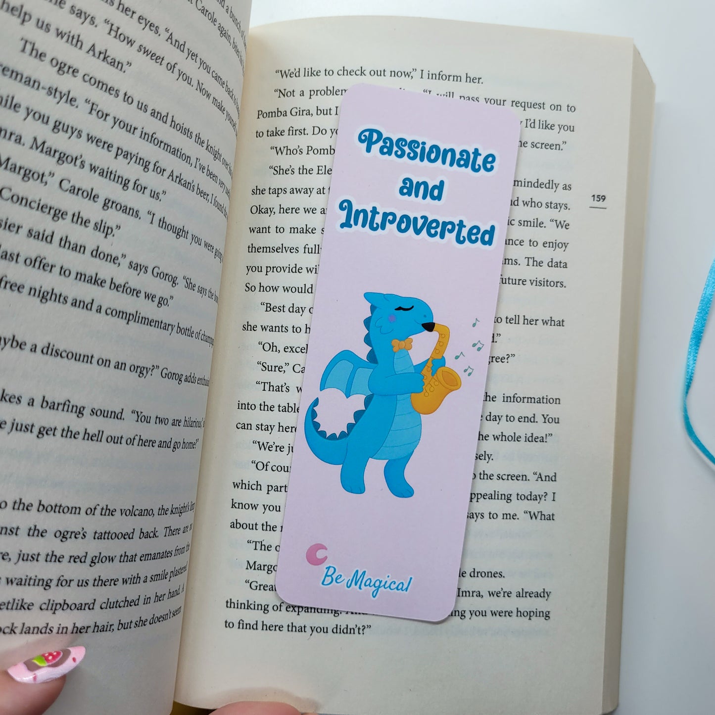 bookmark featuring "passionate and introverted" with a blue dragon playing the saxophone