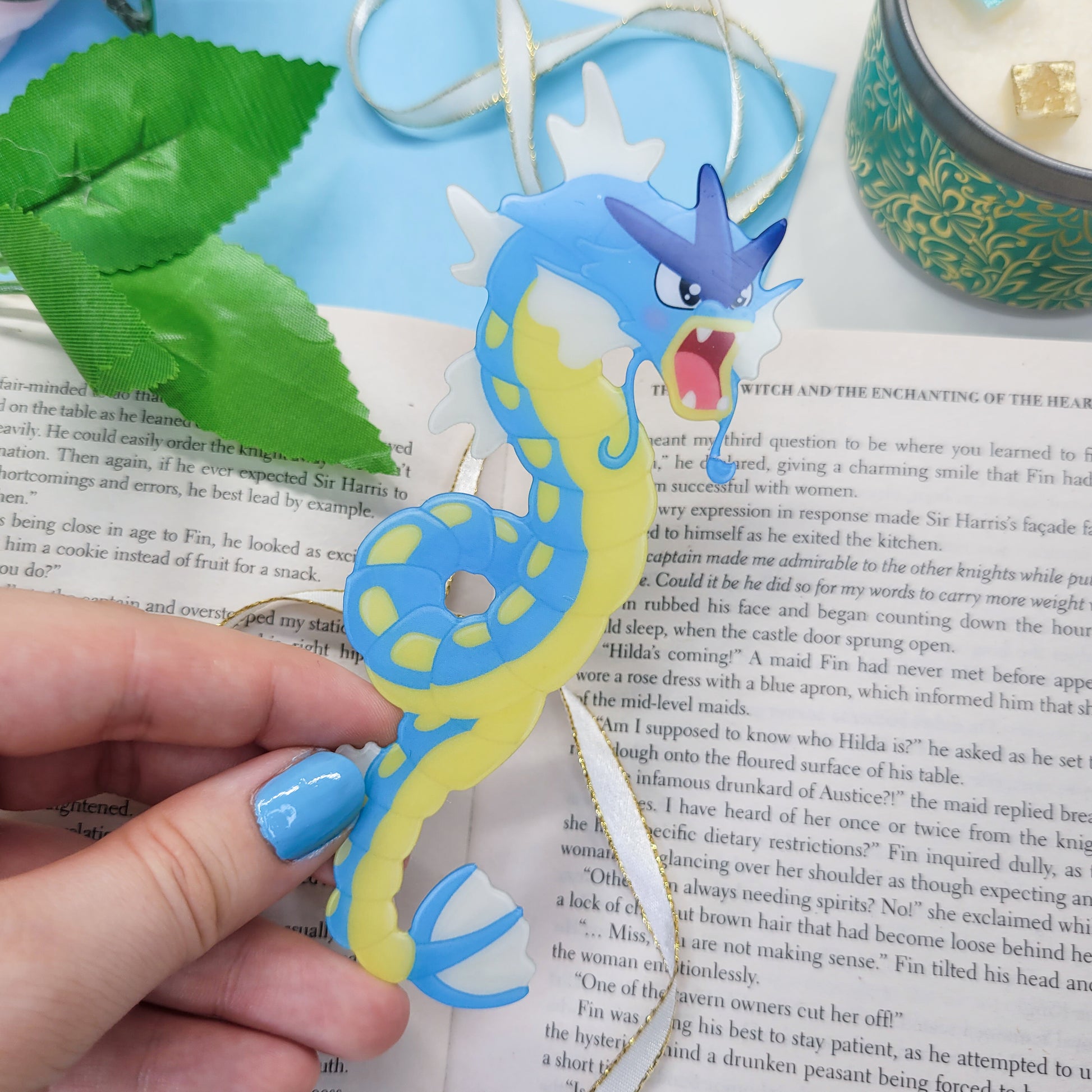 Gyrados shaped bookmark shown in use