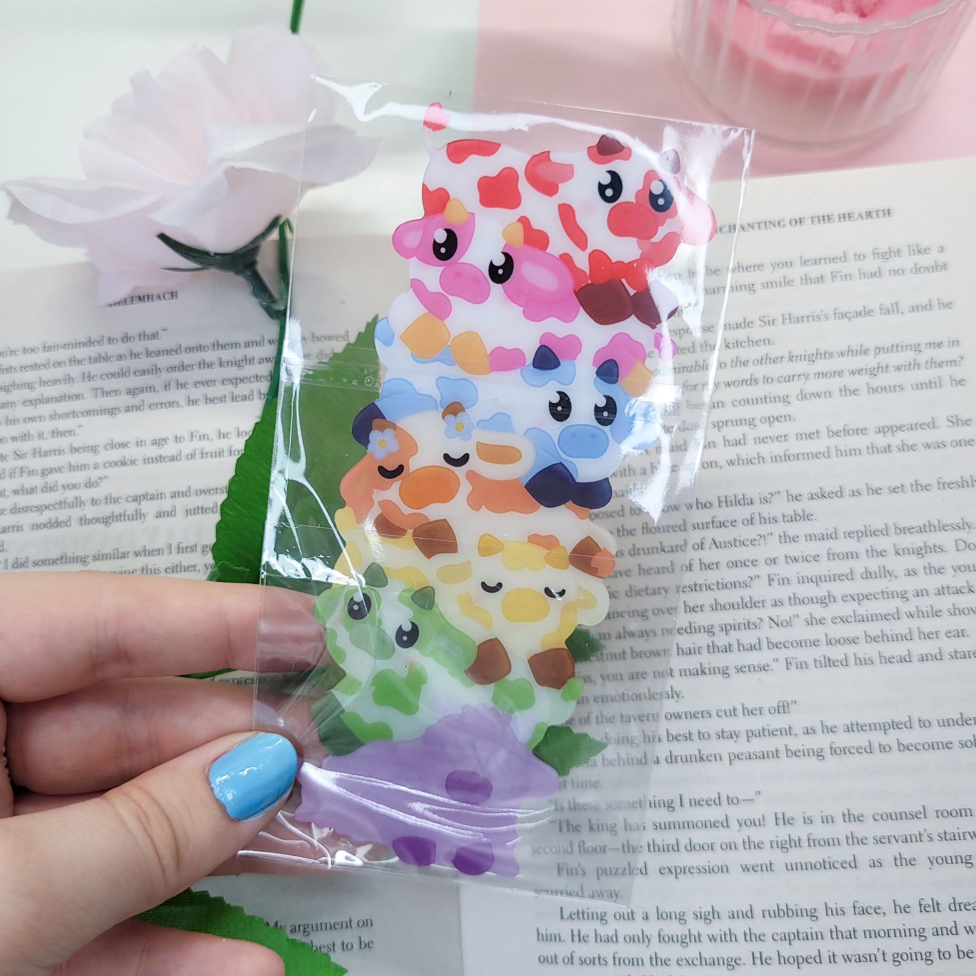 Cute stack of cows shaped bookmark shown in use