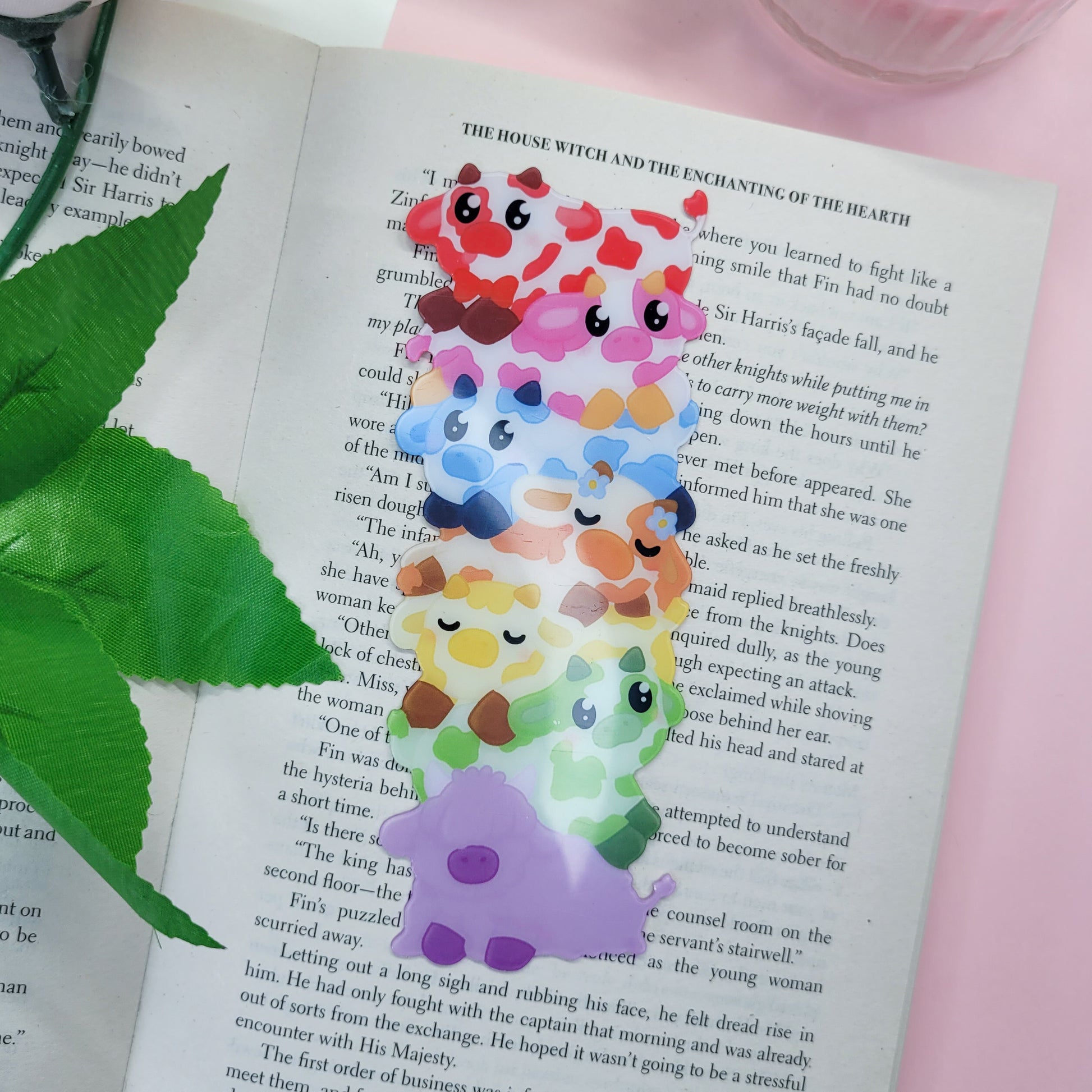 Cute stack of cows shaped bookmark shown in use