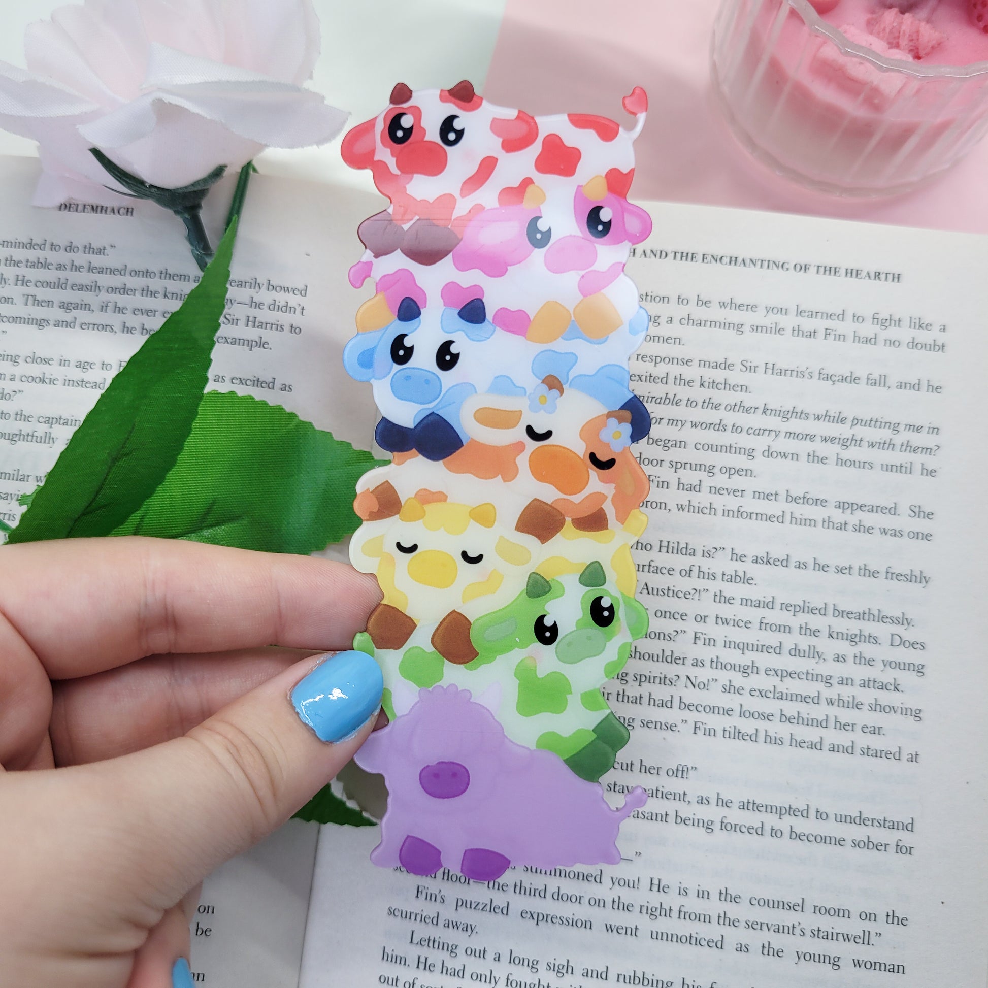 Cute stack of cows shaped bookmark shown in use