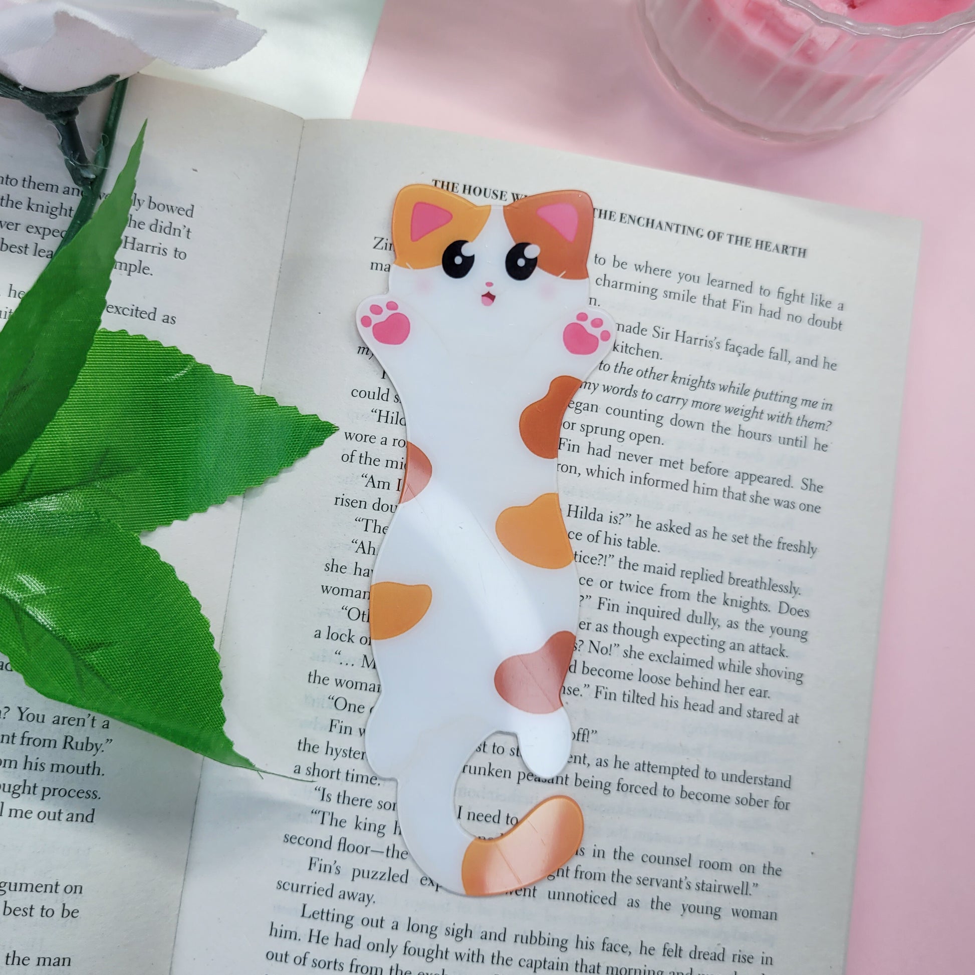Cute cat shaped bookmark shown in use