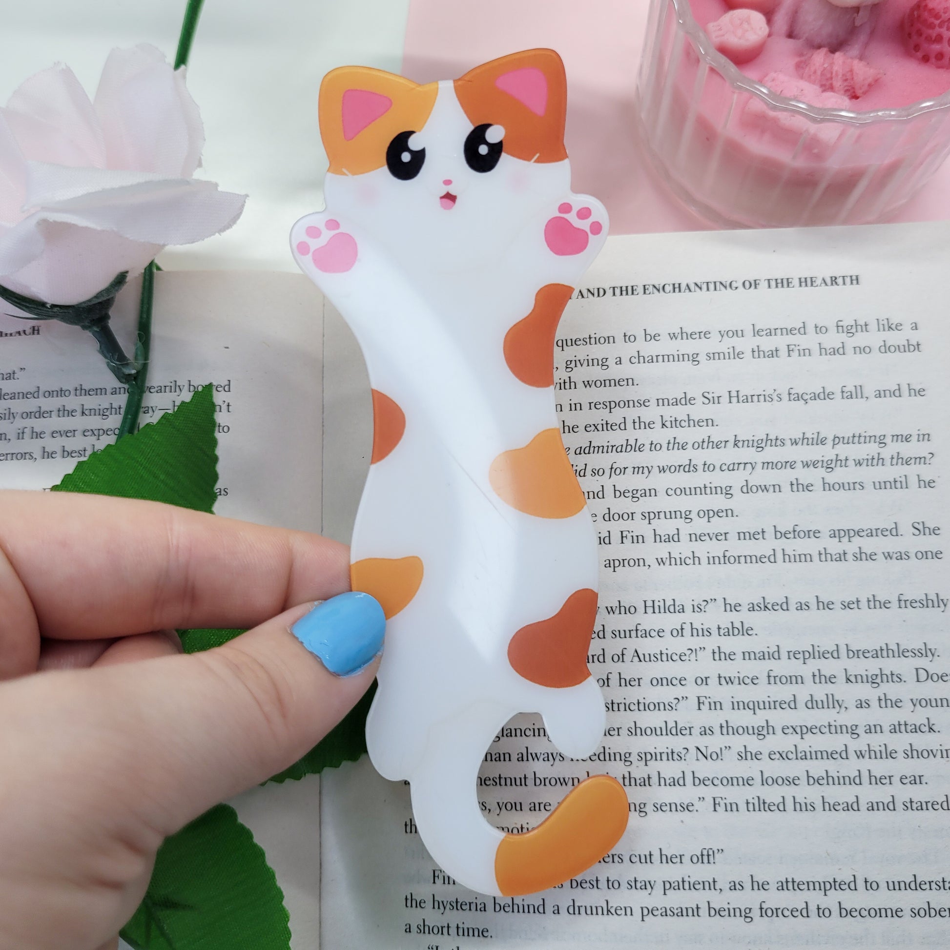 Cute cat shaped bookmark shown in use