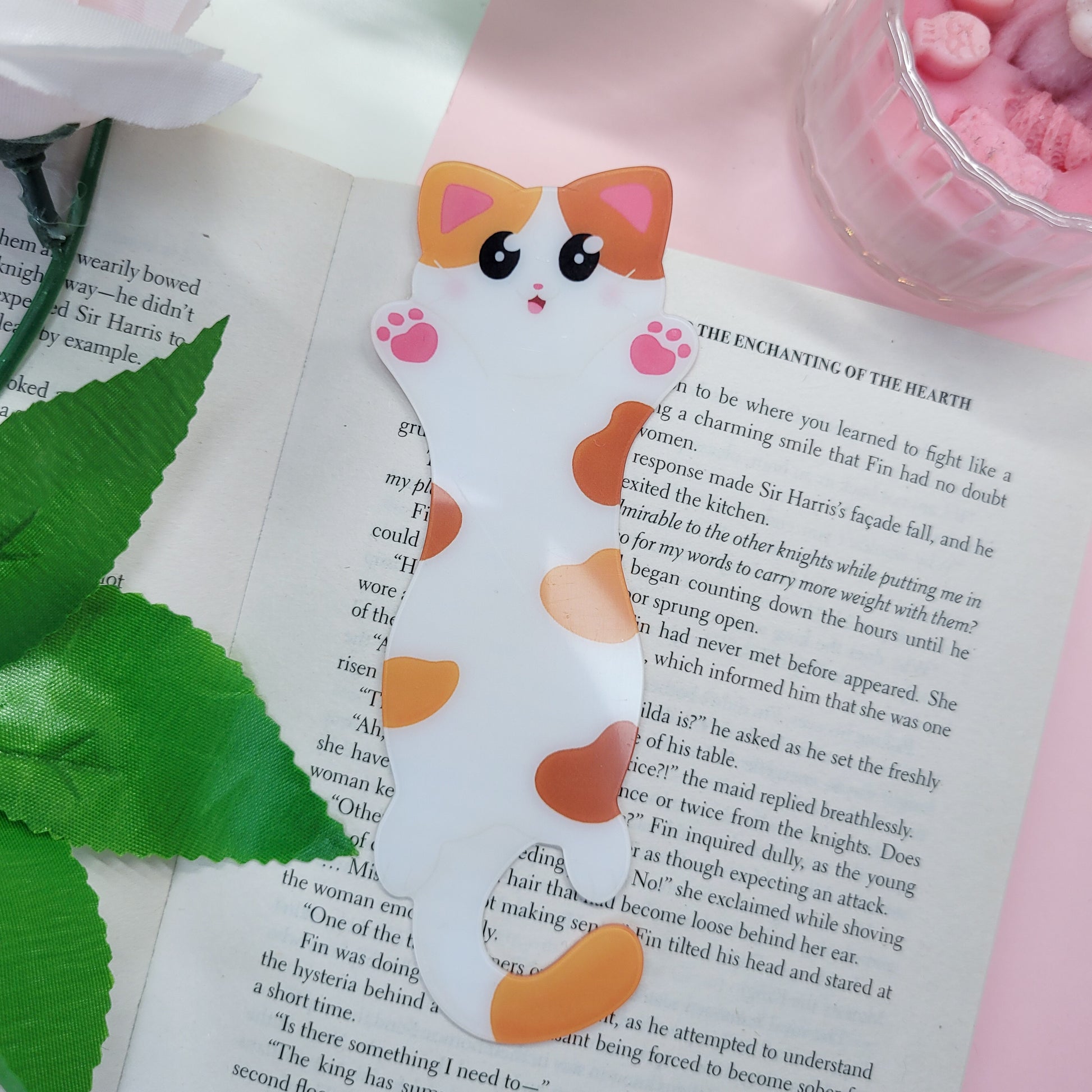 Cute cat shaped bookmark shown in use