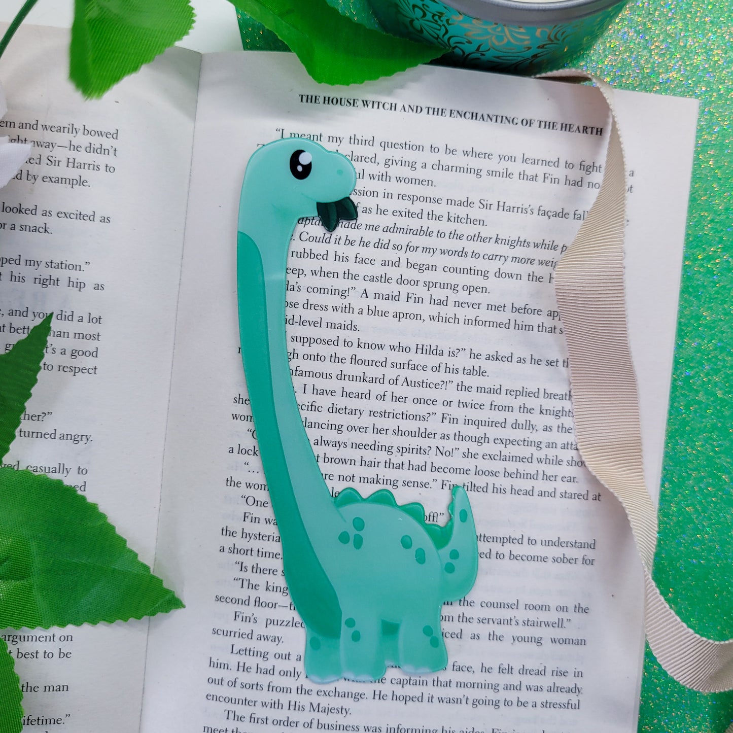 Brachiosaurus shaped bookmark, green brachio, shown on a book