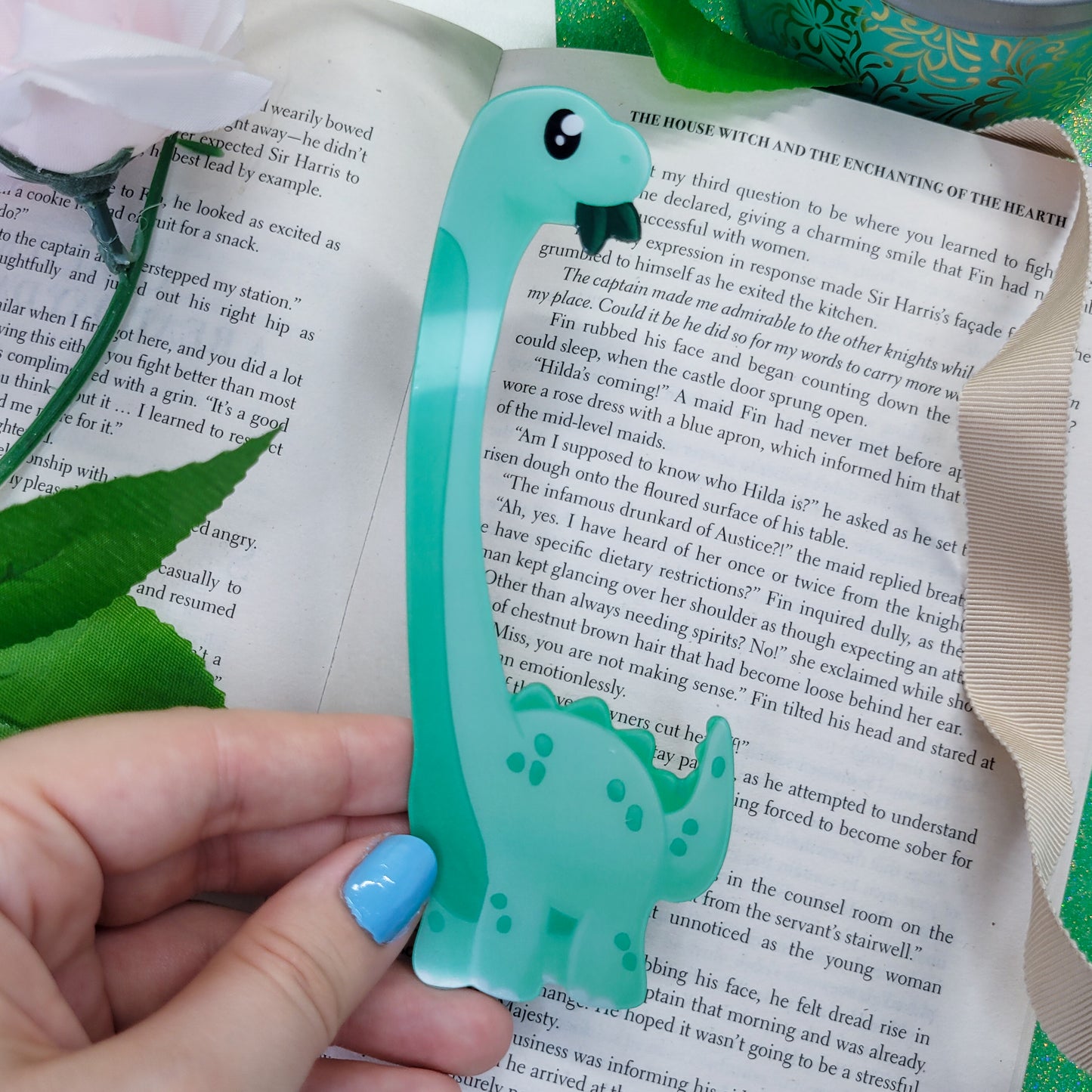 Brachiosaurus shaped bookmark, green brachio, shown on a book