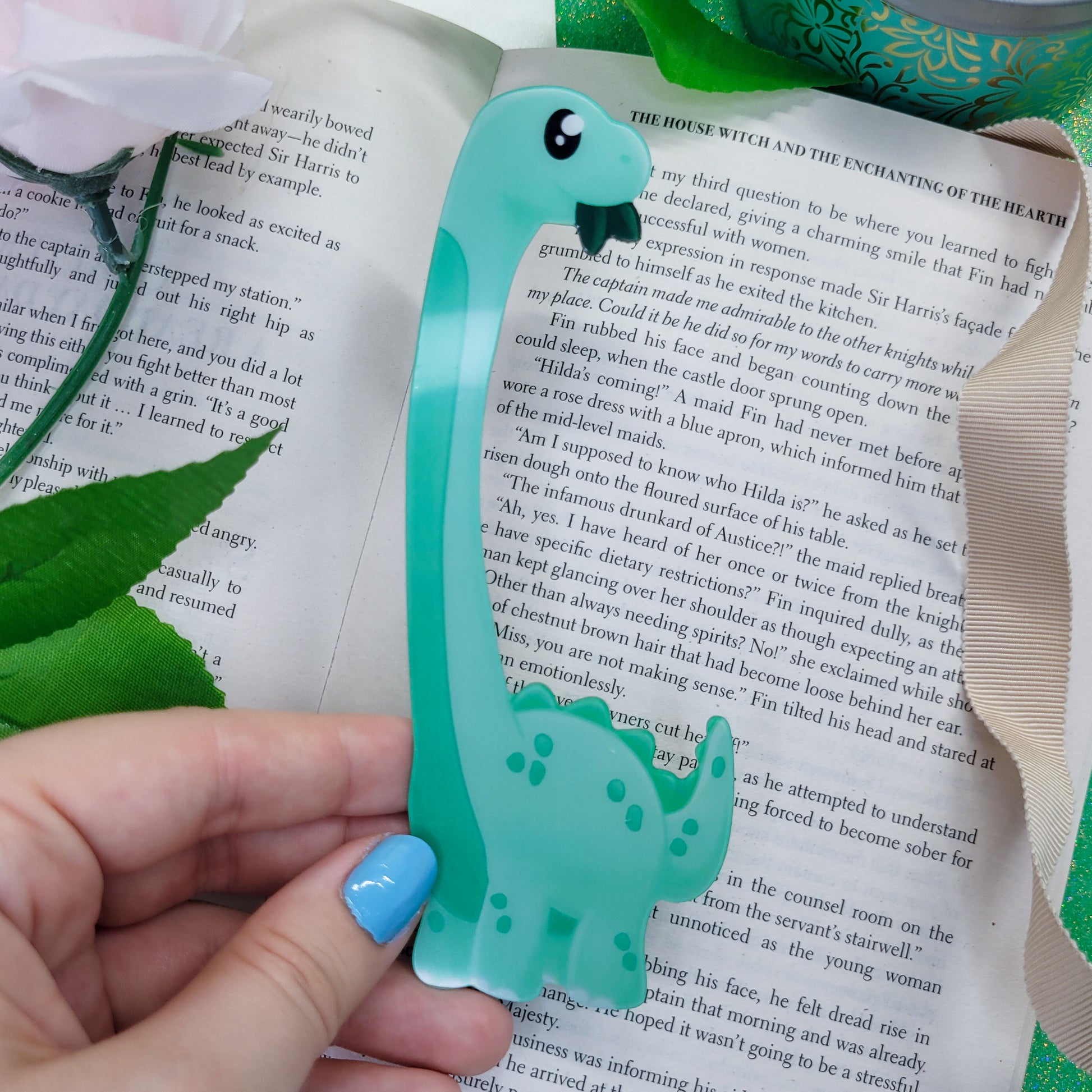 Brachiosaurus shaped bookmark, green brachio, shown on a book