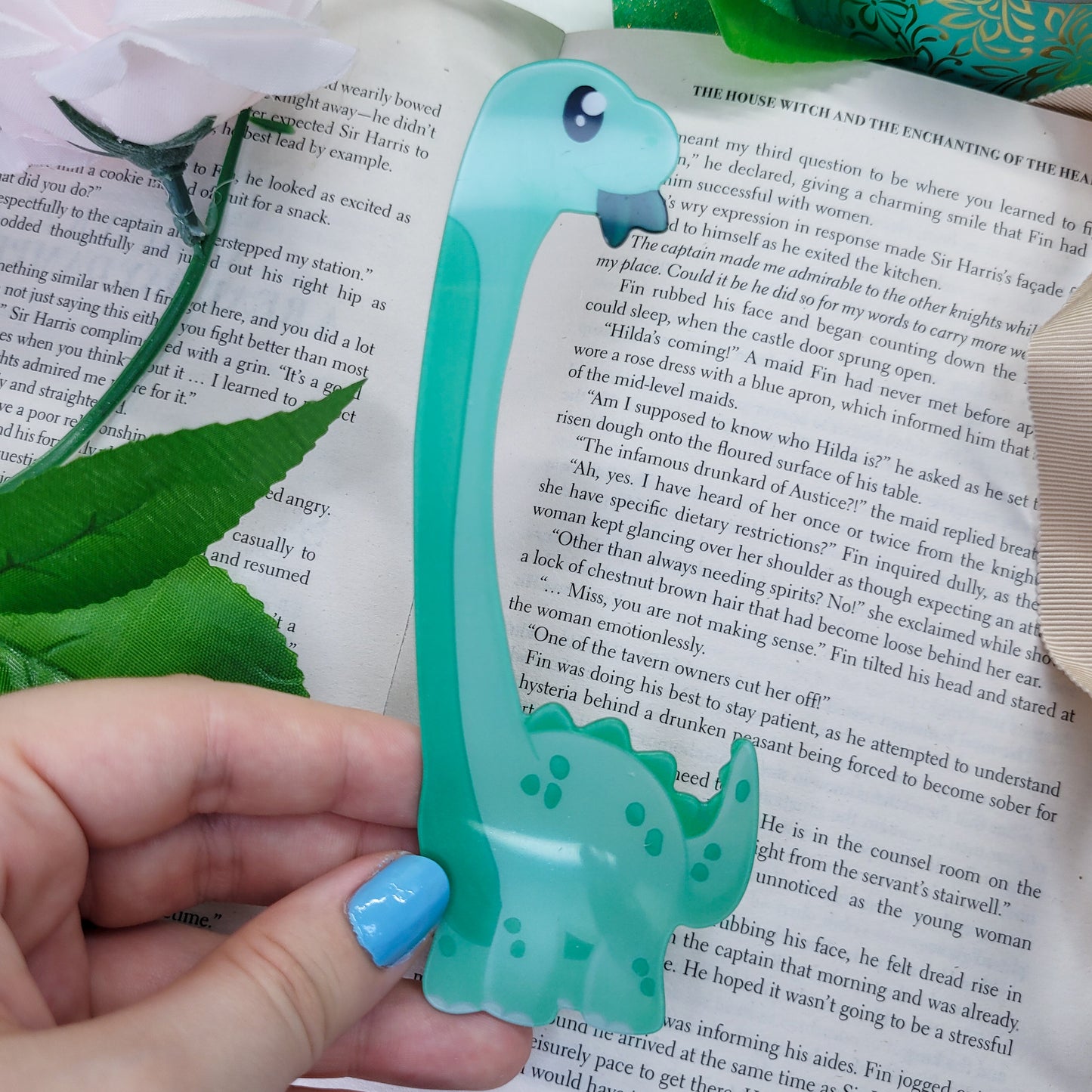 Brachiosaurus shaped bookmark, green brachio, shown on a book