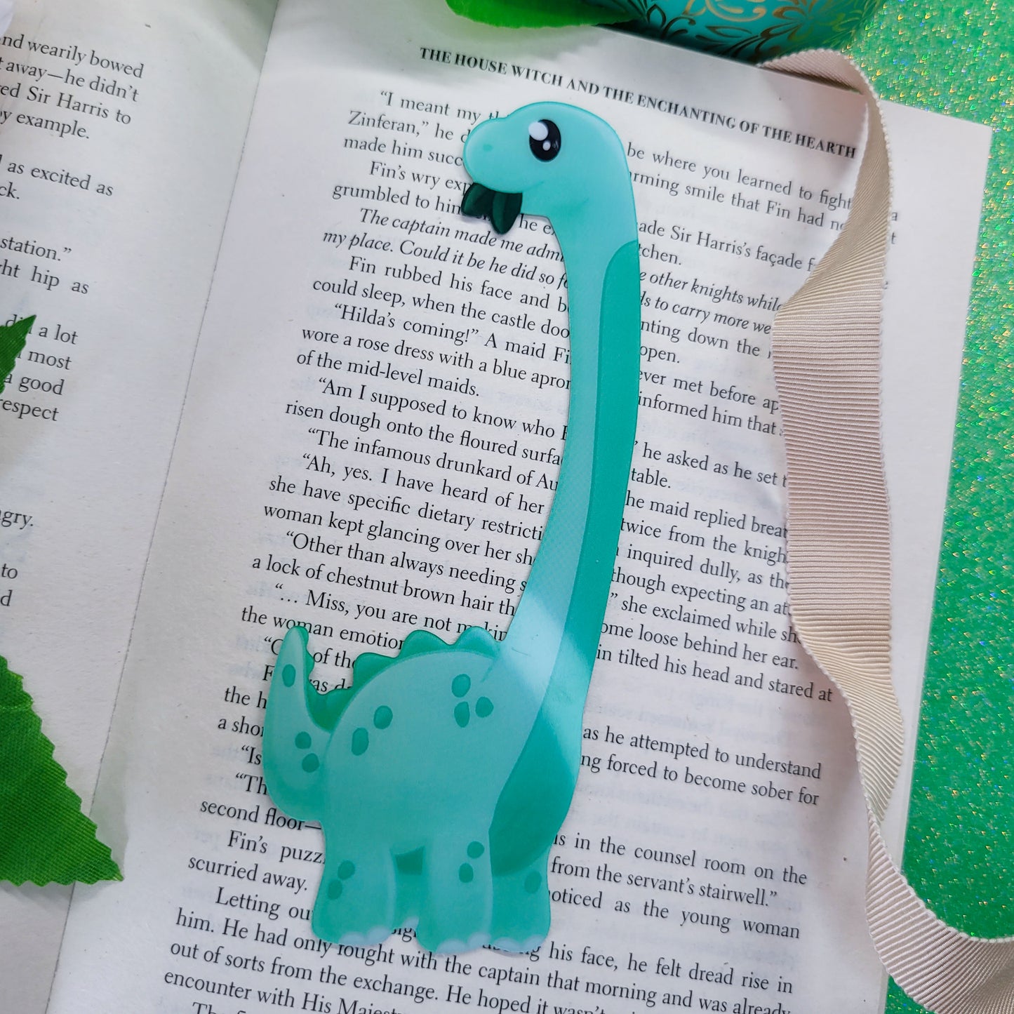Brachiosaurus shaped bookmark, green brachio, shown on a book