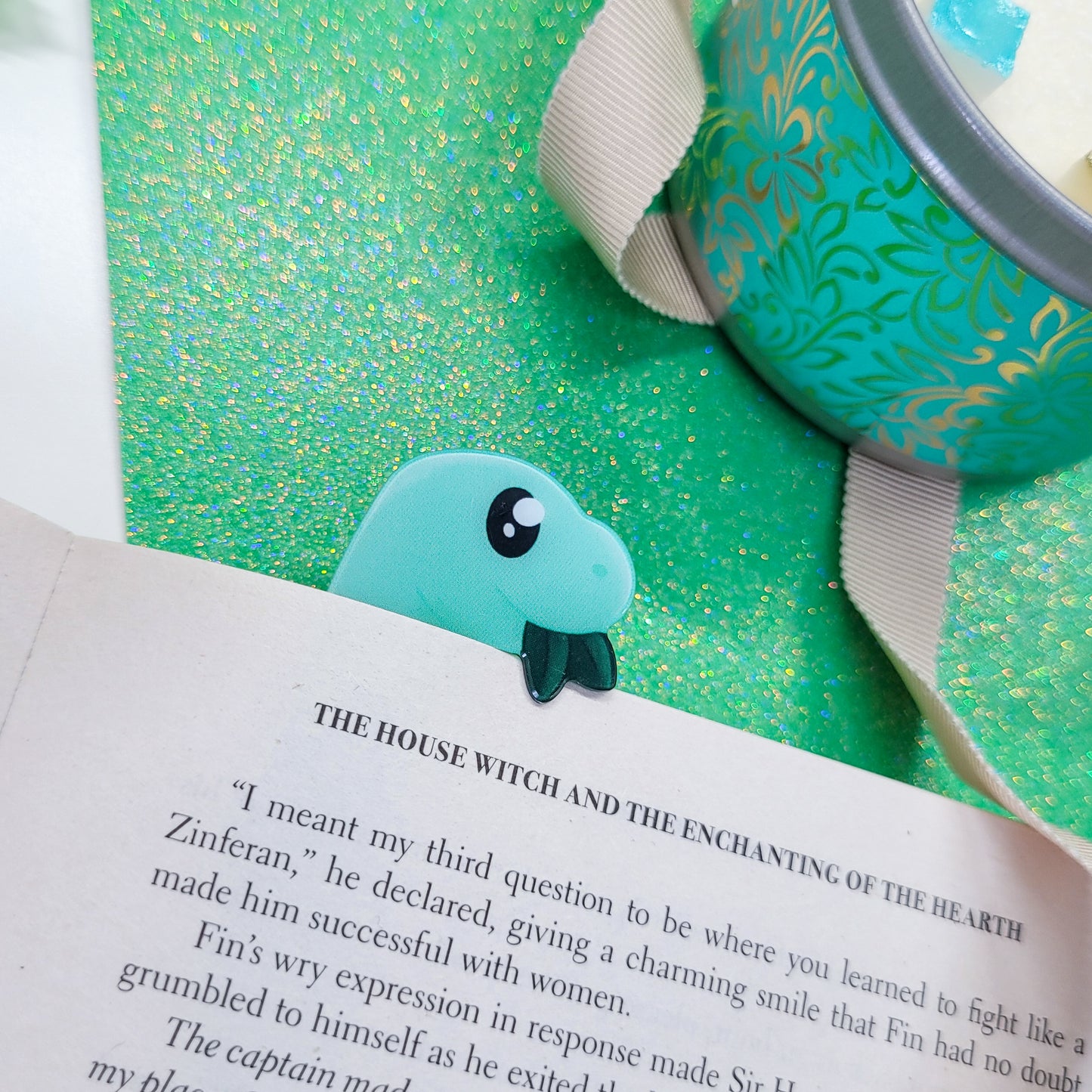 Brachiosaurus shaped bookmark, green brachio, shown on a book