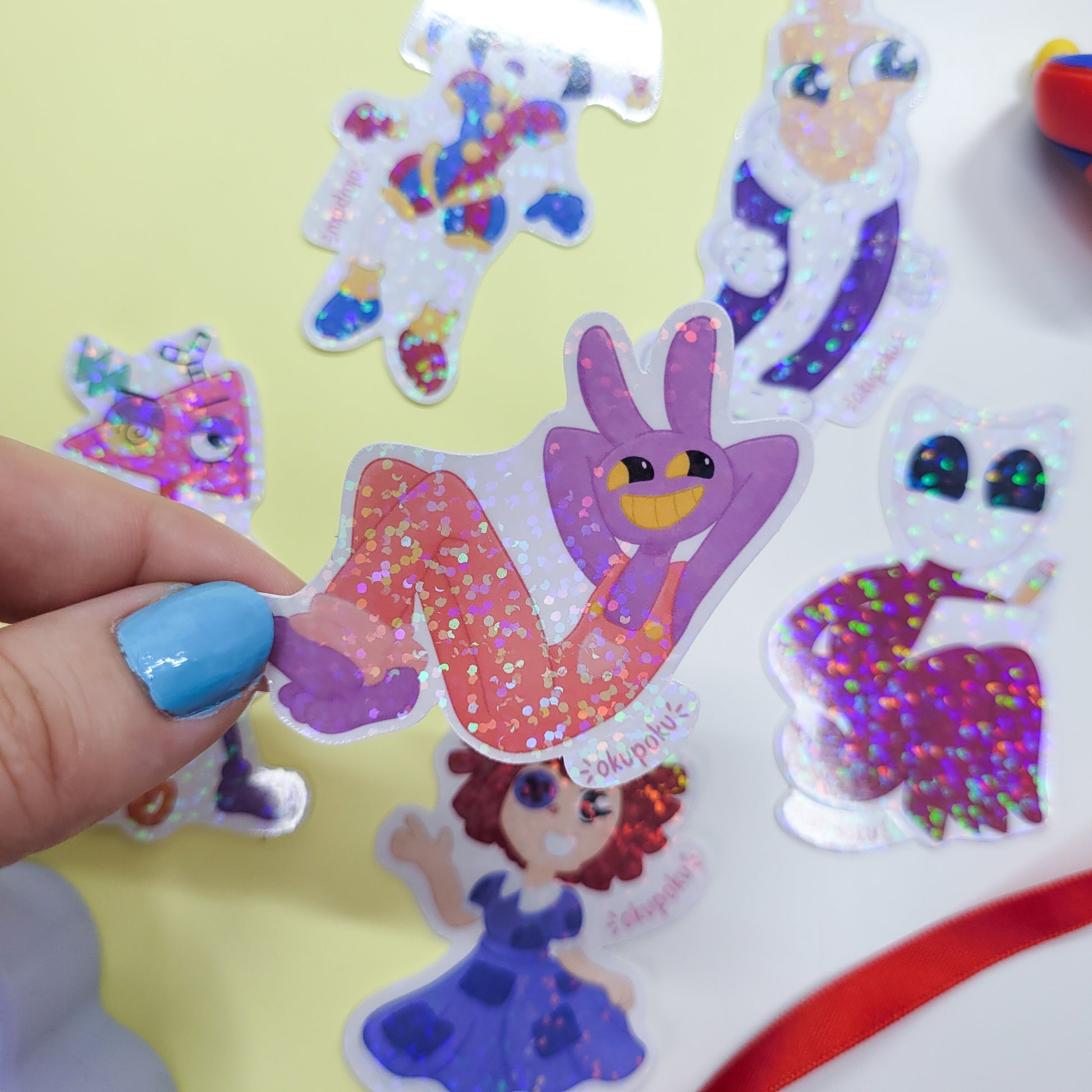 The Amazing Digital Circus sticker pack featuring the main six characters shown in use