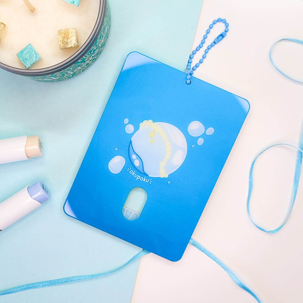 Water themed photocard holder made out of acryllic with blue chain