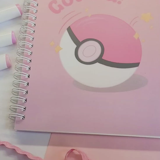 reusable sticker book with a Poké Ball design and 'Gotcha!' text on a pink background