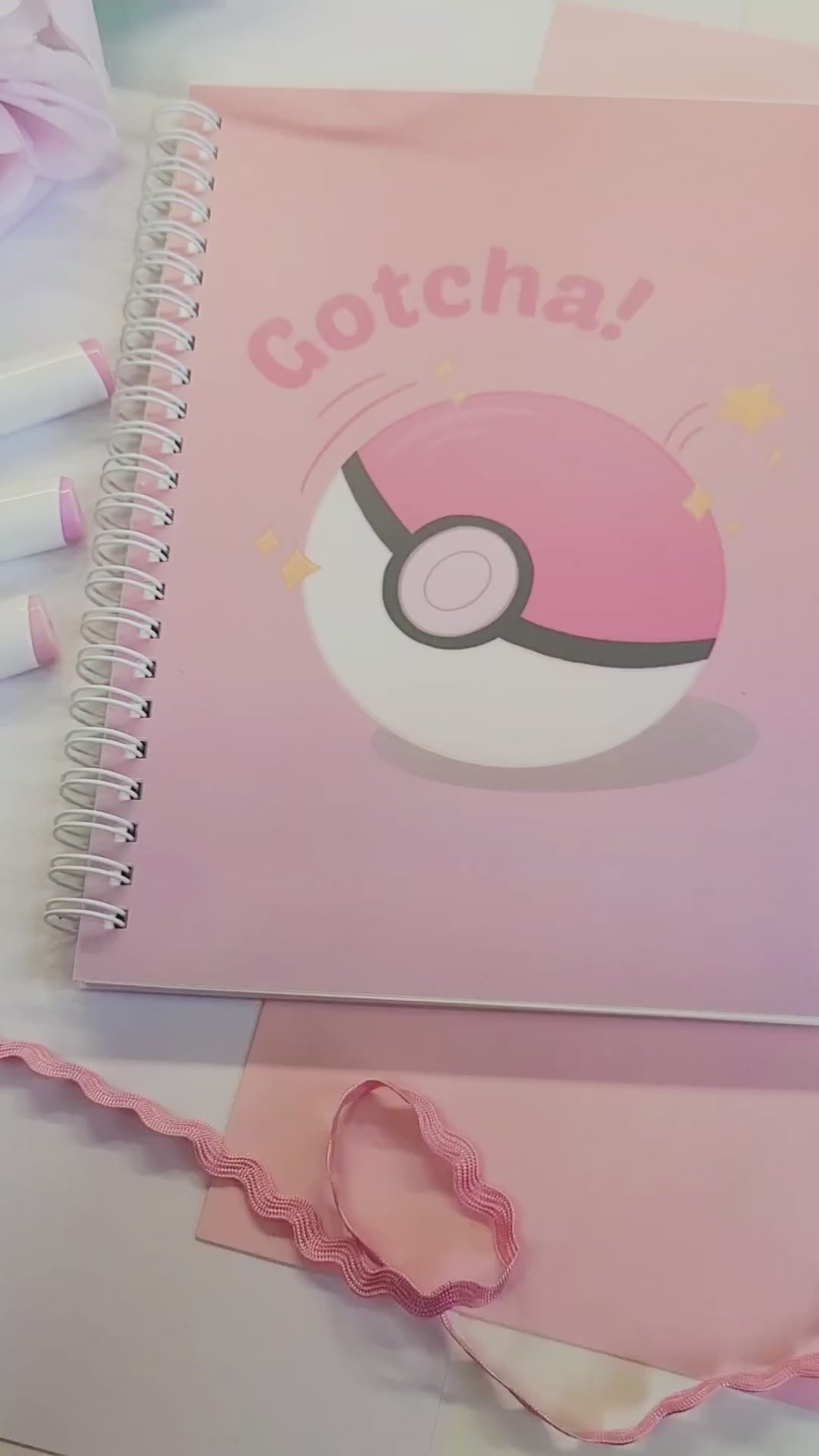 reusable sticker book with a Poké Ball design and 'Gotcha!' text on a pink background